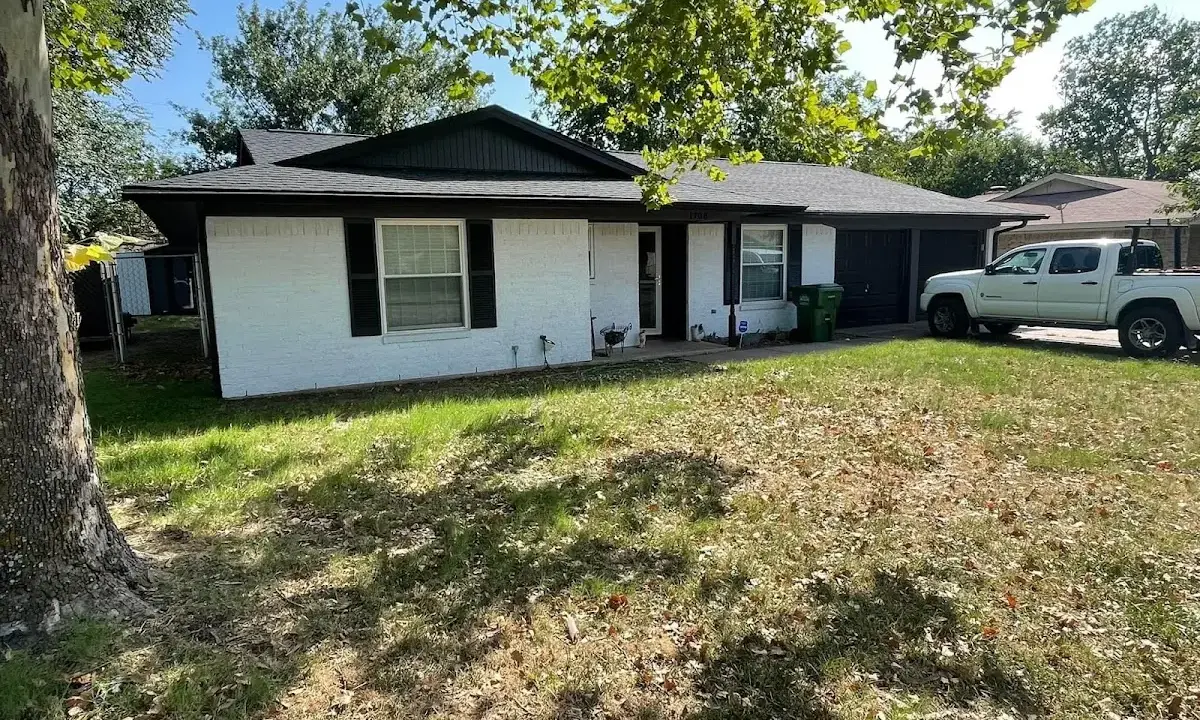 Professional roofing crew working on a residential roof in De Soto